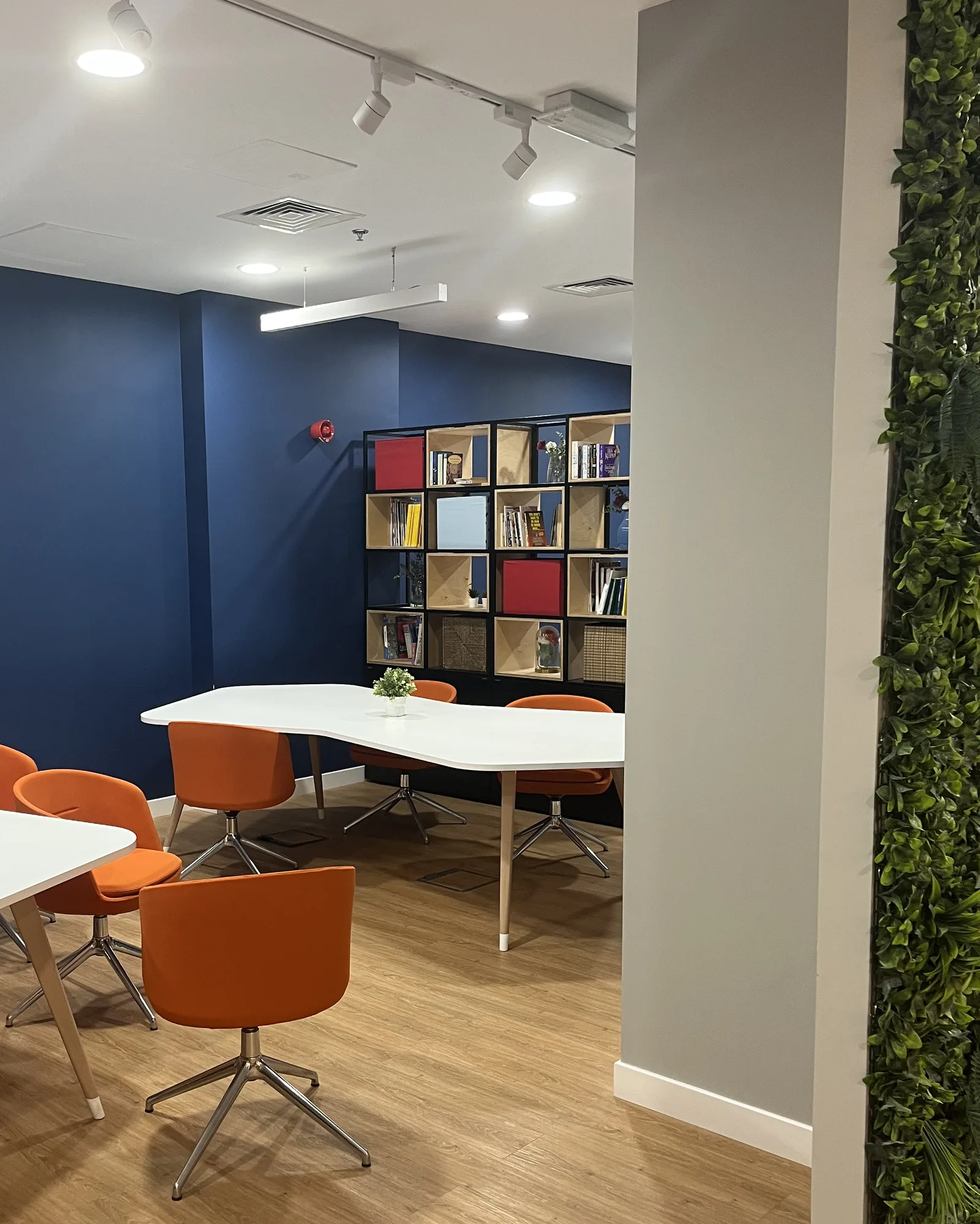 Meeting area at Orfloat Corporate Office with orange chairs and blue walls