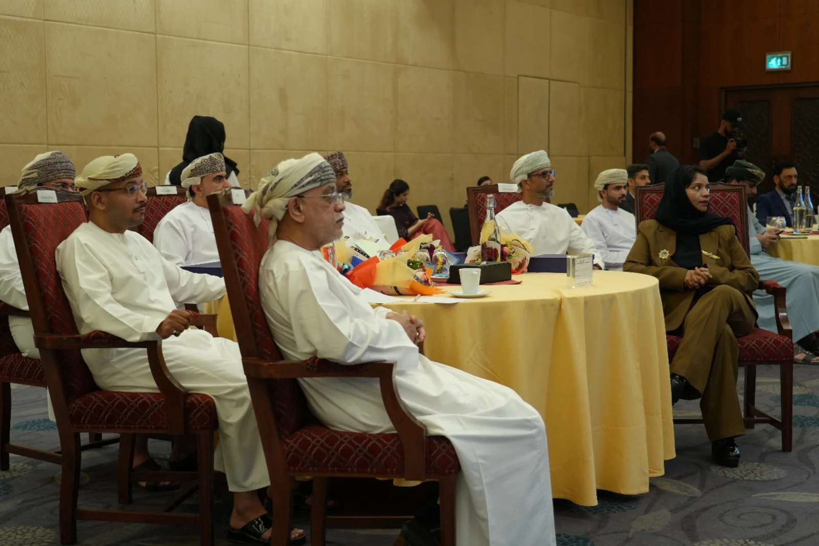 Attendees seated around a table during a Business Carnival stage session