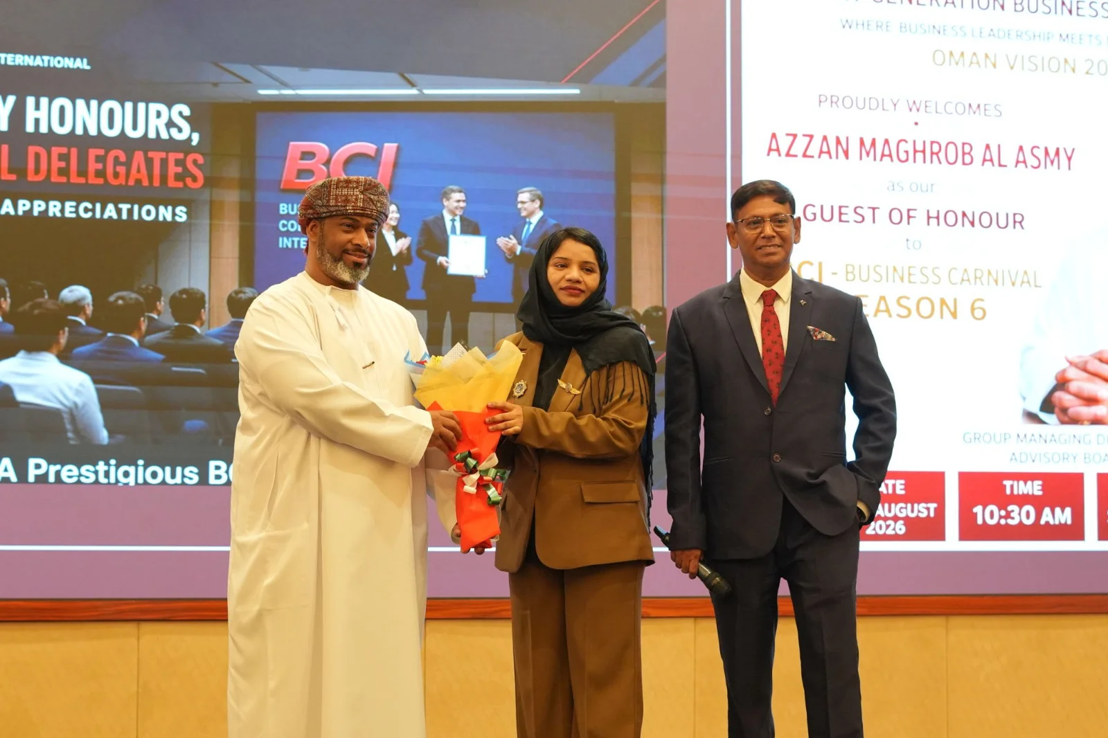 Three people on stage during a flower presentation at Business Carnival Season 6
