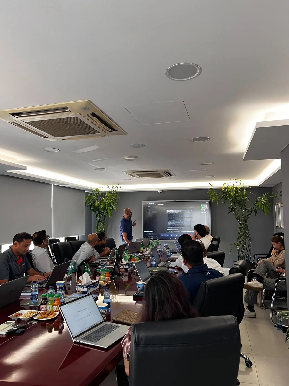 A live AI demonstration for Europcar Oman staff gathered around a conference table